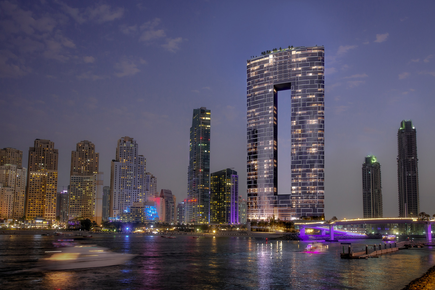 Hotel-branded residence towers on the Dubai shoreline at dusk